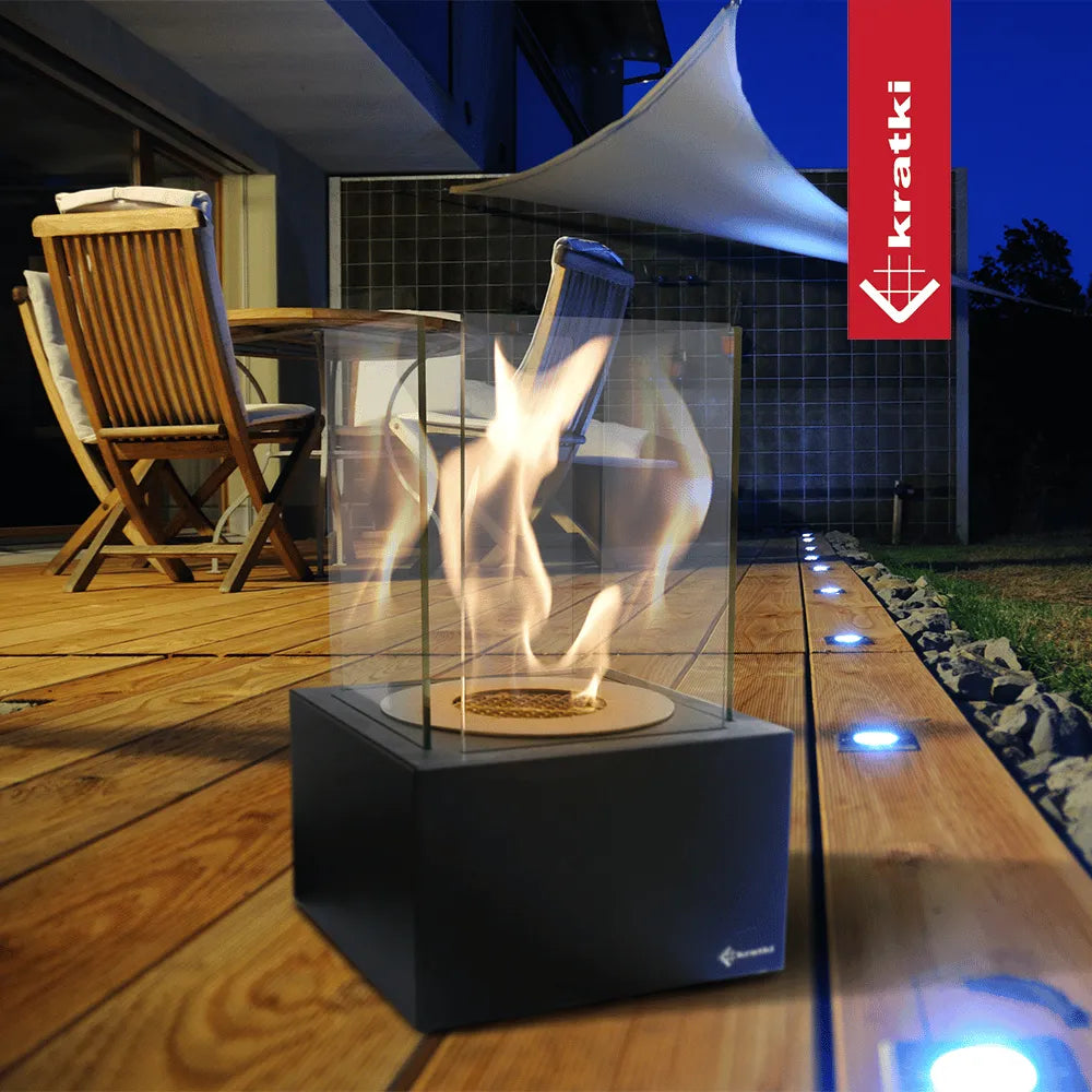 Kratki Tango2 TÜV op houten terras bij avond, met moderne buitenmeubels en sfeerverlichting.