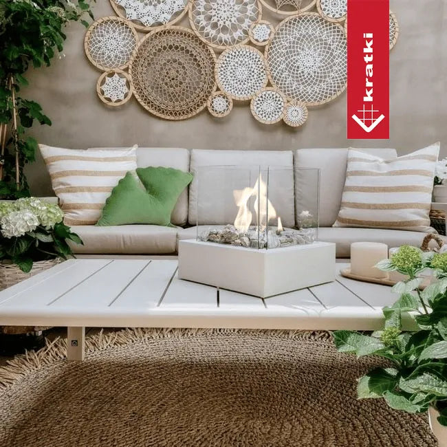 Gezellige zithoek met Kratki Tango3 TÜV haard, omringd door planten en decoratieve wandkunst.