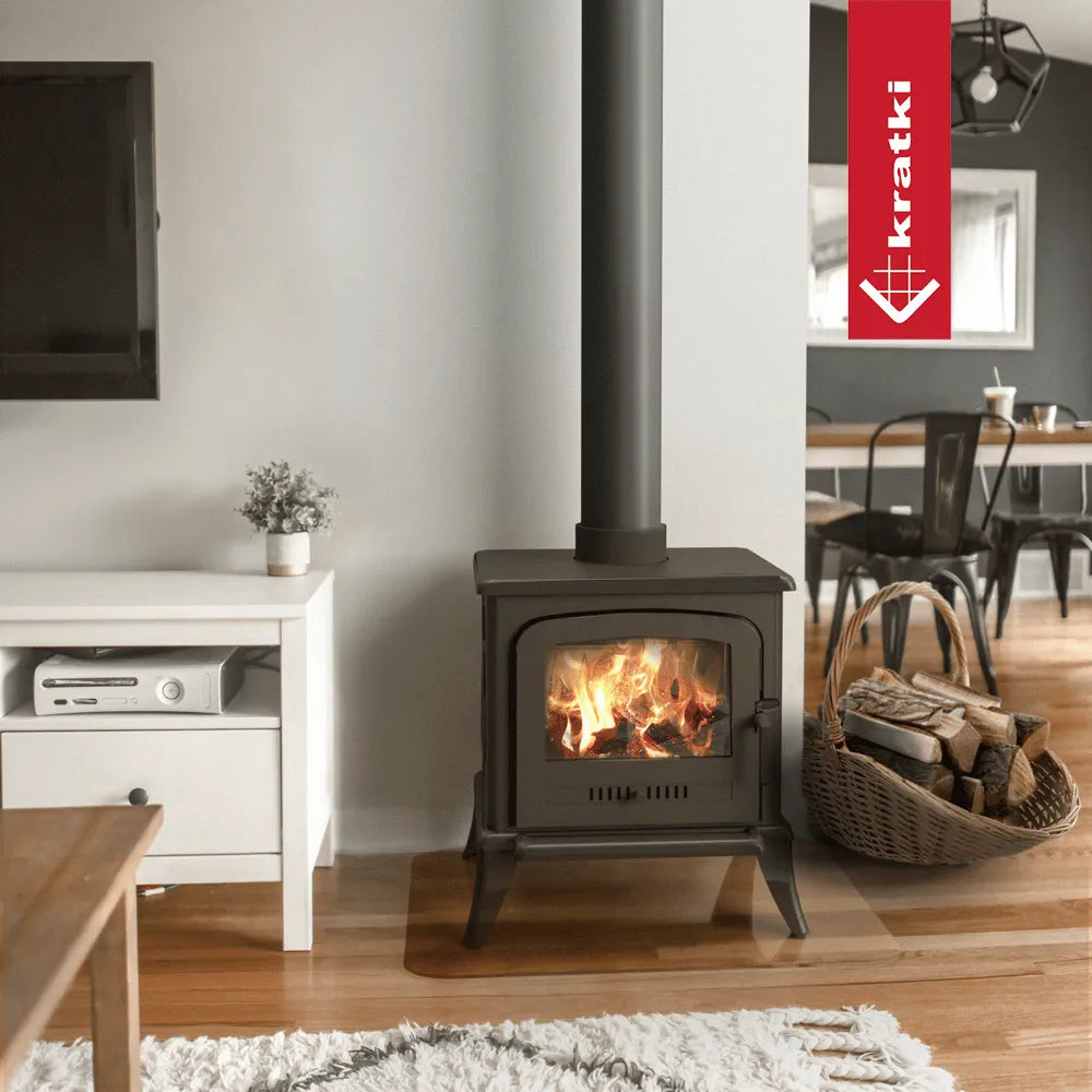 Kratki K7 houtkachel in een moderne woonkamer met houten vloer en mand met brandhout.