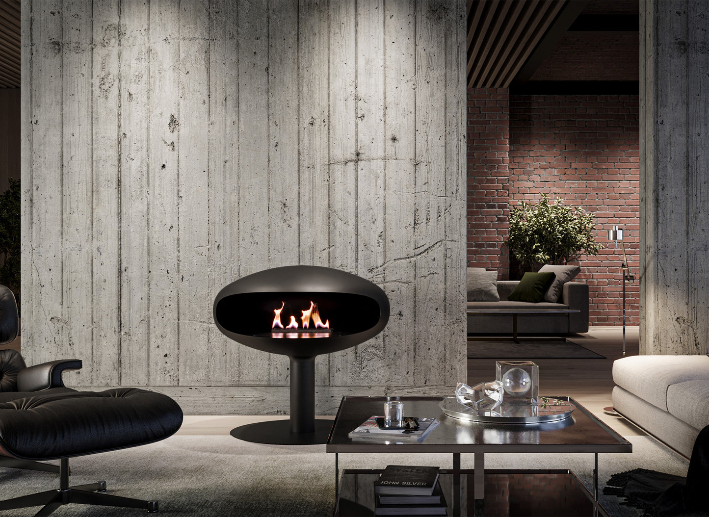 Icon Fires The Iconic 900 pedestal in a modern living room with concrete and brick walls.