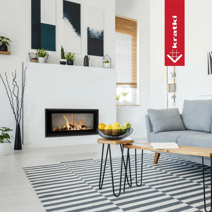 Moderne woonkamer met Kratki MB100 haard, grijze bank, fruitmand en zwart-wit gestreept tapijt.