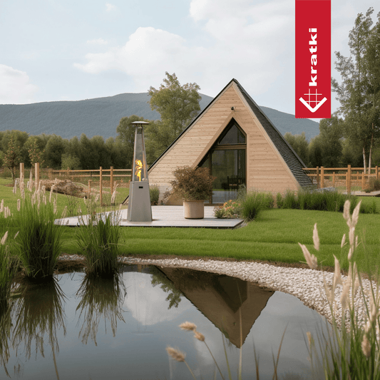 Kratki Umbrella terrasverwarmer naast A-vormig huis in tuin