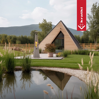 Kratki Umbrella terrasverwarmer naast houten A-frame huis