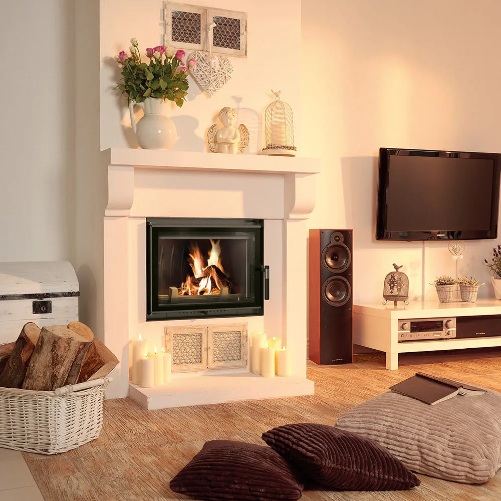 Gezellige woonkamer met brandende Kratki Zuzia Eco haard, omringd door kaarsen en decoraties.