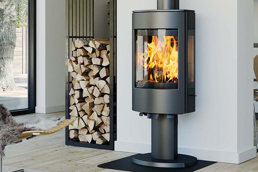 Dovre Astro 4CB/P houtkachel met voet in moderne woonkamer, met brandend vuur