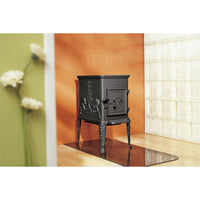 Dovre 100CBS/B houtkachel in een interieur met oranje wand