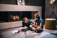 Faber Matrix 1050/500 III Driezijdig in moderne woonkamer met brandende haard
